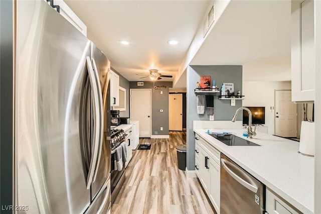 950 Seven Hills Dr Unit 814, Henderson, NV 89052 - kitchen featuring light countertops, a sink, appliances with stainless steel finishes, light wood-type flooring, and white cabinets