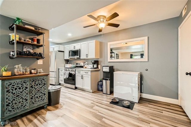 950 Seven Hills Dr Unit 814, Henderson, NV 89052 - kitchen featuring a ceiling fan, white cabinetry, light wood-style flooring, stainless steel appliances, and baseboards