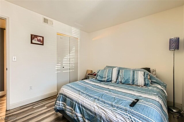 950 Seven Hills Dr Unit 814, Henderson, NV 89052 - bedroom featuring baseboards, visible vents, a closet, and wood finished floors