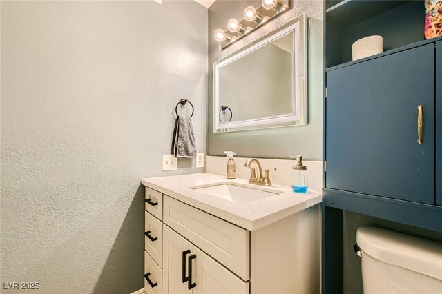 950 Seven Hills Dr Unit 814, Henderson, NV 89052 - bathroom featuring toilet, vanity, and a textured wall