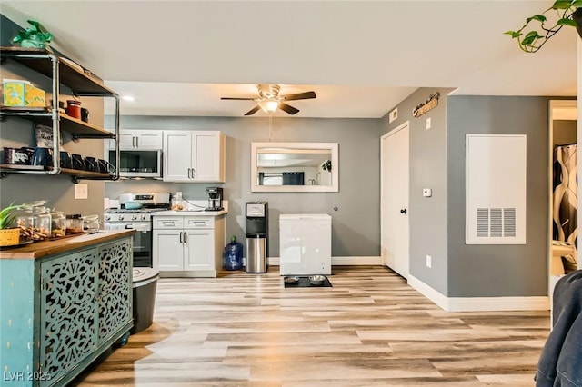 950 Seven Hills Dr Unit 814, Henderson, NV 89052 - kitchen with butcher block counters, light wood-style floors, ceiling fan, and appliances with stainless steel finishes