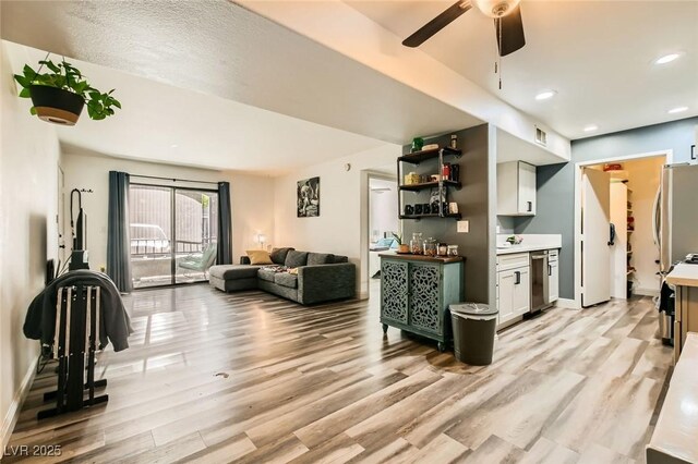 950 Seven Hills Dr Unit 814, Henderson, NV 89052 - living room featuring baseboards, visible vents, light wood-style floors, ceiling fan, and recessed lighting