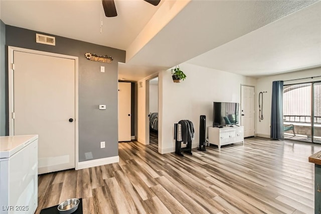 950 Seven Hills Dr Unit 814, Henderson, NV 89052 - living area featuring light wood-type flooring, a ceiling fan, baseboards, and visible vents