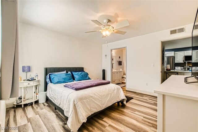 950 Seven Hills Dr Unit 814, Henderson, NV 89052 - bedroom with a ceiling fan, freestanding refrigerator, light wood-type flooring, ensuite bathroom, and visible vents