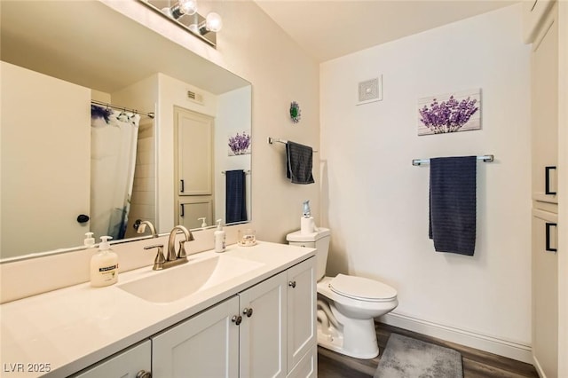 950 Seven Hills Dr Unit 814, Henderson, NV 89052 - bathroom featuring vanity, toilet, baseboards, visible vents, and wood finished floors