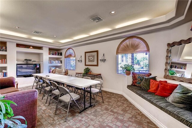 950 Seven Hills Dr Unit 814, Henderson, NV 89052 - dining room with baseboards, visible vents, built in features, and a raised ceiling