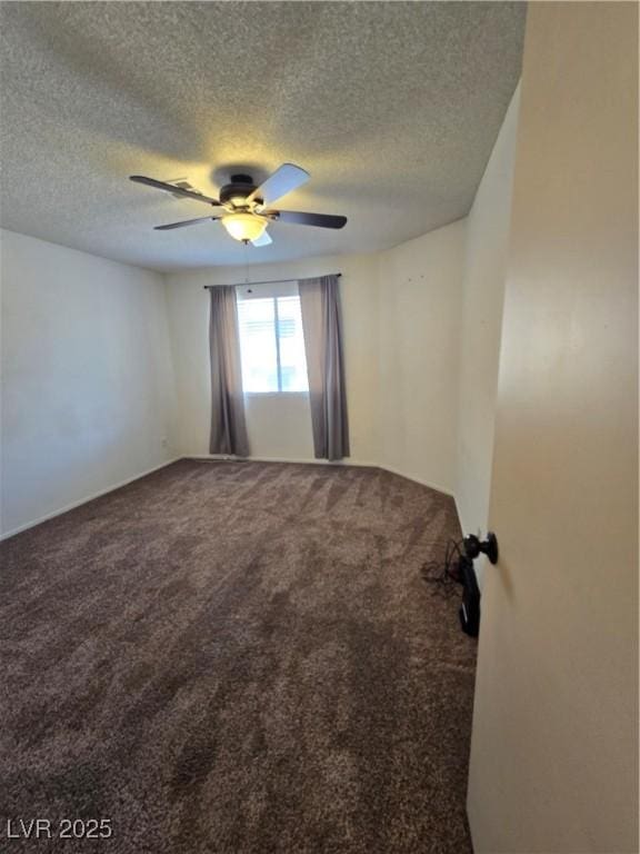 carpeted empty room with a textured ceiling and a ceiling fan