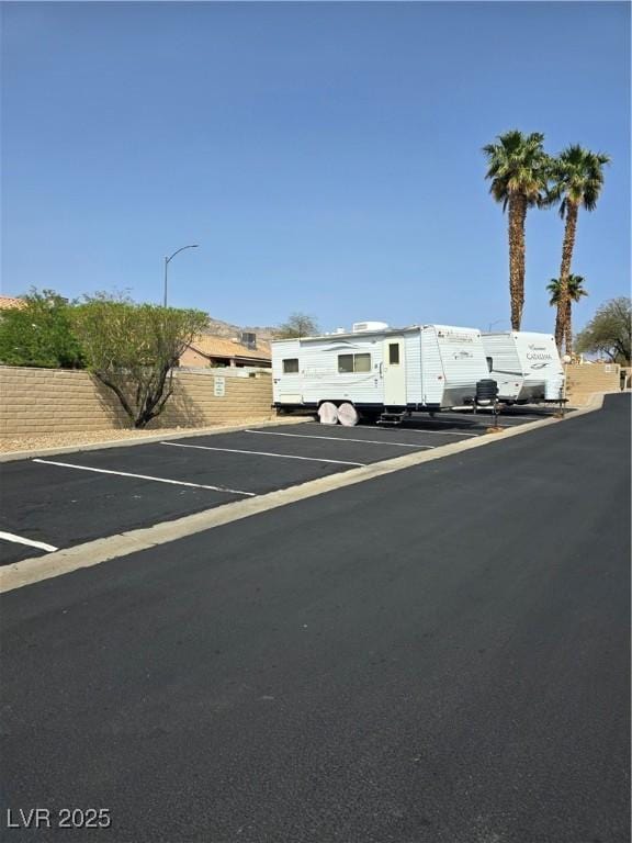 view of front of property featuring uncovered parking and fence