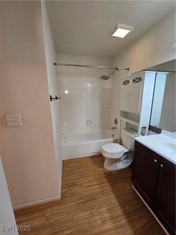 bathroom with shower / bathtub combination, vanity, toilet, and wood finished floors