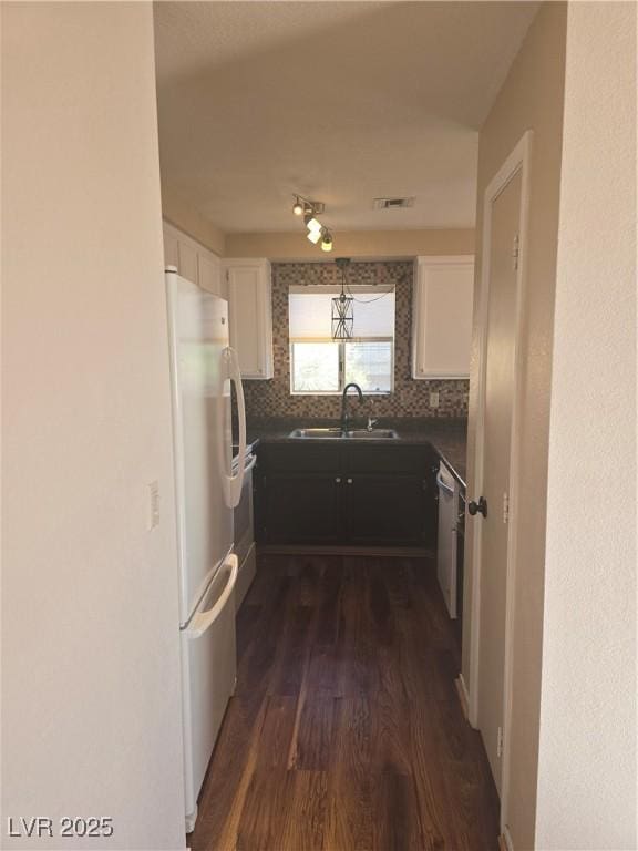 2232 Aspen Mirror Way Unit 204, Laughlin, NV 89029 - kitchen featuring a sink, freestanding refrigerator, dark wood-style floors, white cabinetry, and decorative backsplash