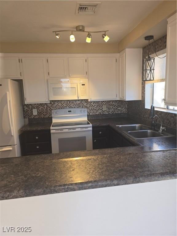 2232 Aspen Mirror Way Unit 204, Laughlin, NV 89029 - kitchen with white appliances, a sink, white cabinetry, and dark countertops