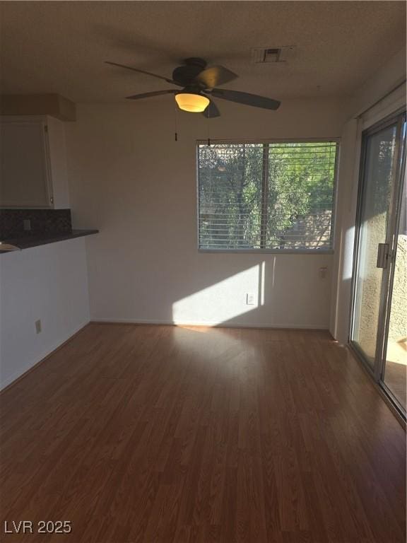 2232 Aspen Mirror Way Unit 204, Laughlin, NV 89029 - unfurnished living room featuring wood finished floors, ceiling fan, and baseboards