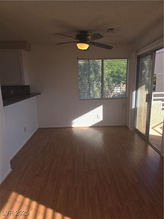 2232 Aspen Mirror Way Unit 204, Laughlin, NV 89029 - unfurnished living room featuring wood finished floors, ceiling fan, and baseboards