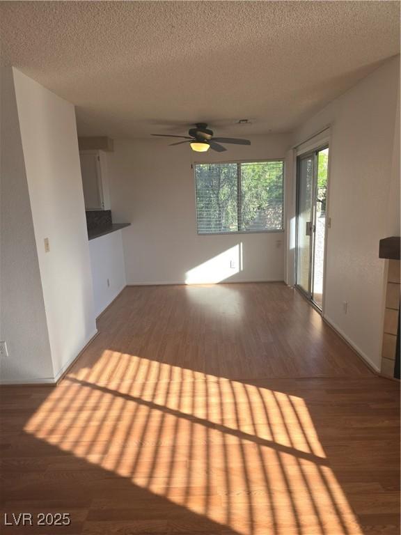 2232 Aspen Mirror Way Unit 204, Laughlin, NV 89029 - unfurnished living room featuring wood finished floors, ceiling fan, and a textured ceiling
