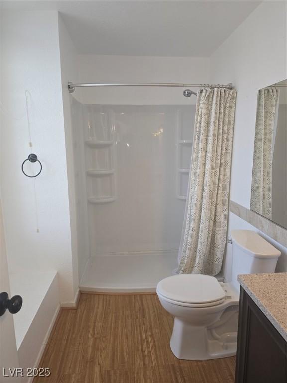 2232 Aspen Mirror Way Unit 204, Laughlin, NV 89029 - bathroom with wood finished floors, toilet, a shower with curtain, and vanity