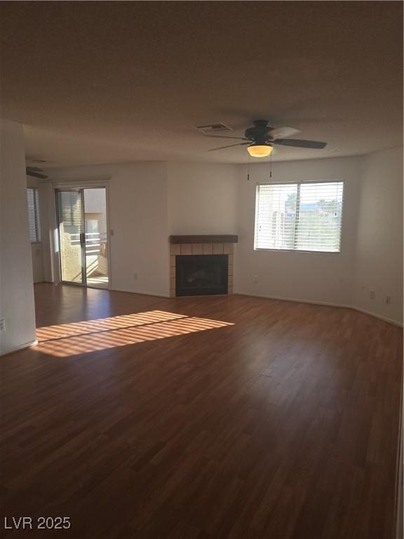2232 Aspen Mirror Way Unit 204, Laughlin, NV 89029 - unfurnished living room with wood finished floors, a tile fireplace, and a ceiling fan