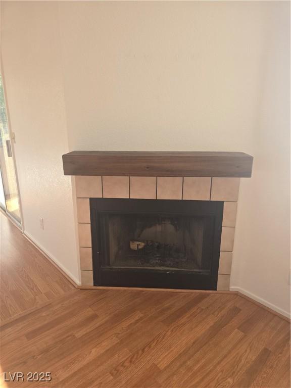 2232 Aspen Mirror Way Unit 204, Laughlin, NV 89029 - detailed view of wood finished floors, a tiled fireplace, and baseboards