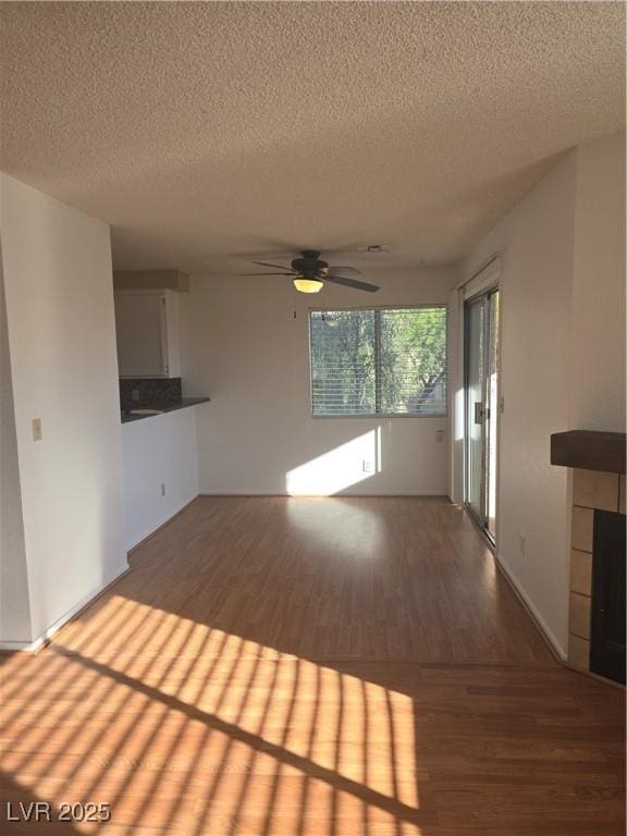 2232 Aspen Mirror Way Unit 204, Laughlin, NV 89029 - unfurnished living room with wood finished floors, a textured ceiling, and a ceiling fan