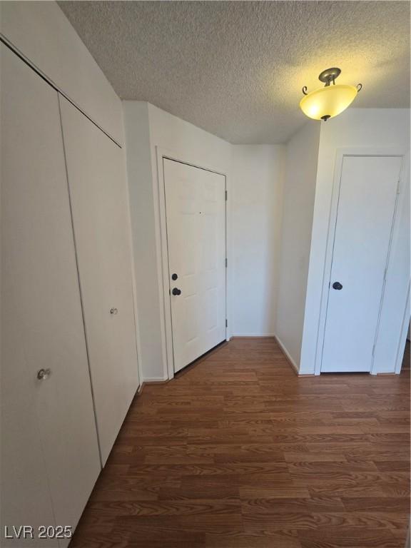 2232 Aspen Mirror Way Unit 204, Laughlin, NV 89029 - corridor featuring wood finished floors, a textured ceiling, and baseboards