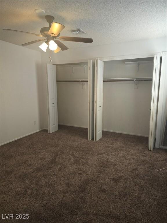 2232 Aspen Mirror Way Unit 204, Laughlin, NV 89029 - unfurnished bedroom featuring carpet, two closets, a textured ceiling, and ceiling fan