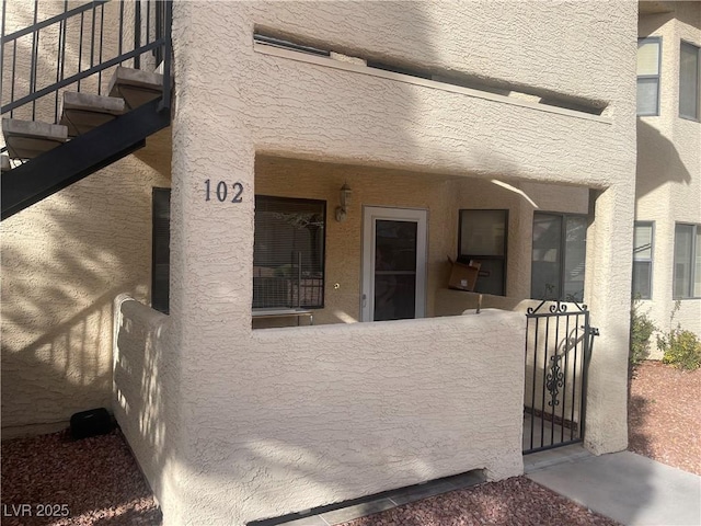 property entrance featuring stucco siding