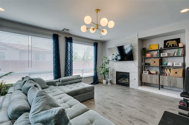 11769 Via Vera Cruz Ct, Las Vegas, NV 89138 - living area featuring a chandelier, wood finished floors, a fireplace, recessed lighting, and baseboards