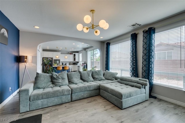 11769 Via Vera Cruz Ct, Las Vegas, NV 89138 - living area with arched walkways, a chandelier, light wood-type flooring, baseboards, and recessed lighting