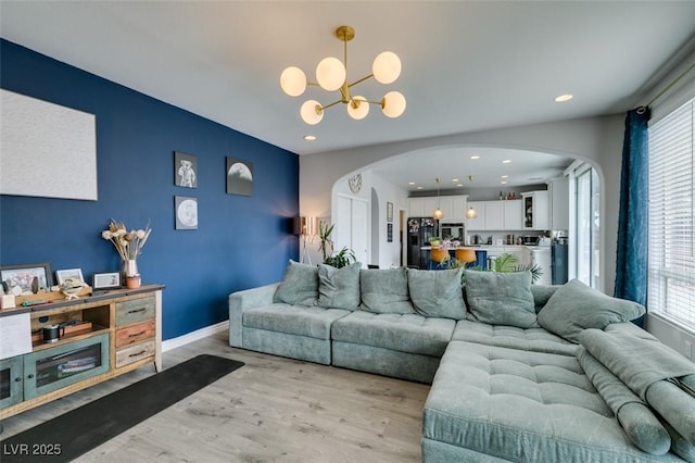 11769 Via Vera Cruz Ct, Las Vegas, NV 89138 - living area with arched walkways, healthy amount of natural light, light wood-type flooring, a chandelier, and recessed lighting