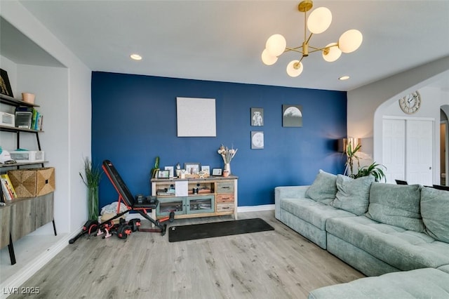 11769 Via Vera Cruz Ct, Las Vegas, NV 89138 - living room featuring arched walkways, wood finished floors, a chandelier, recessed lighting, and baseboards