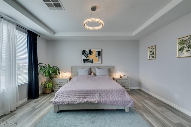 11769 Via Vera Cruz Ct, Las Vegas, NV 89138 - bedroom with a raised ceiling, multiple windows, and wood finished floors