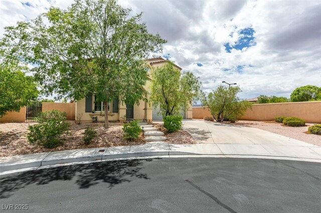 11769 Via Vera Cruz Ct, Las Vegas, NV 89138 - view of front of home with driveway, fence, stucco siding, and a gate