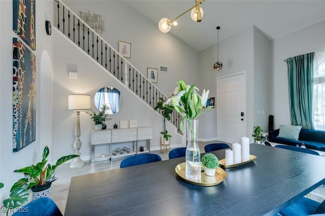 11769 Via Vera Cruz Ct, Las Vegas, NV 89138 - dining space featuring a towering ceiling, baseboards, stairs, and arched walkways