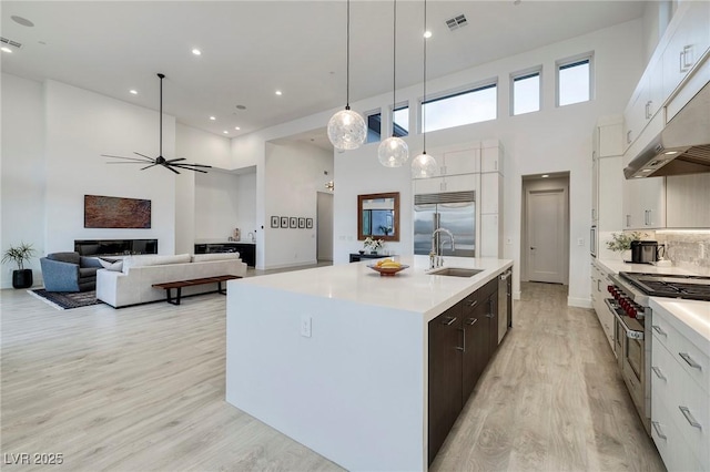 148 Tre Pietre St, Henderson, NV 89011 - kitchen featuring high end appliances, a ceiling fan, visible vents, a high ceiling, and a sink