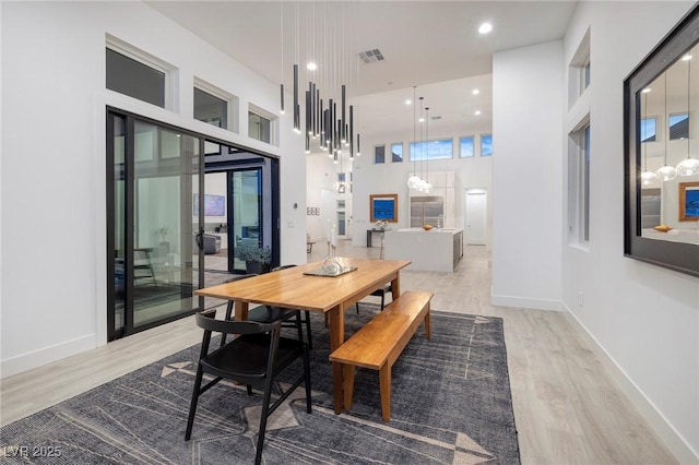 148 Tre Pietre St, Henderson, NV 89011 - dining area with a notable chandelier, visible vents, a high ceiling, and wood finished floors