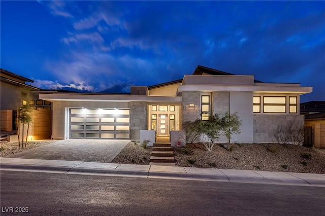 148 Tre Pietre St, Henderson, NV 89011 - contemporary house with an attached garage, driveway, stucco siding, and stone siding