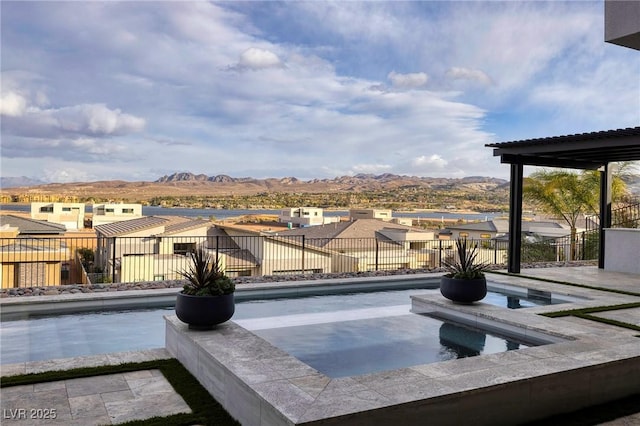 148 Tre Pietre St, Henderson, NV 89011 - view of pool with a mountain view, fence, an in ground hot tub, and a residential view