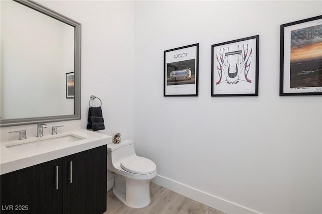 148 Tre Pietre St, Henderson, NV 89011 - half bathroom with vanity, baseboards, toilet, and wood finished floors