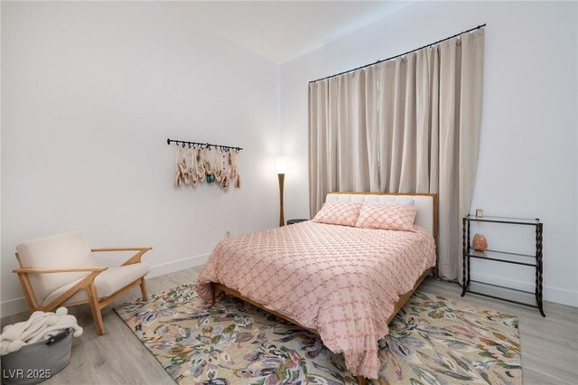 148 Tre Pietre St, Henderson, NV 89011 - bedroom with wood finished floors, baseboards, and vaulted ceiling