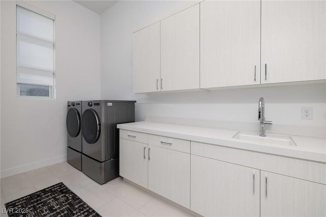 148 Tre Pietre St, Henderson, NV 89011 - laundry room with baseboards, a sink, cabinet space, washing machine and clothes dryer, and light tile patterned flooring