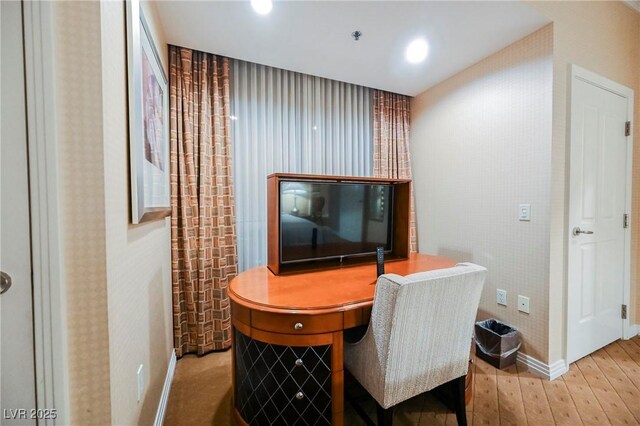 office space with baseboards and wood-type flooring