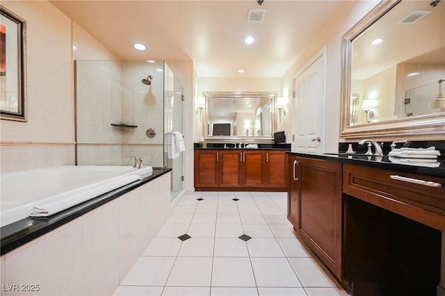 full bathroom featuring tile patterned floors, visible vents, a garden tub, a sink, and tiled shower