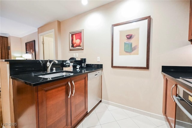 interior space featuring tile patterned flooring, baseboards, and a sink