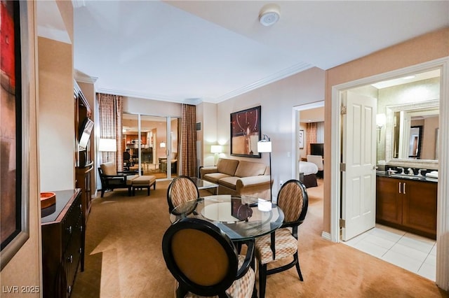 dining room featuring light tile patterned floors, light colored carpet, and ornamental molding