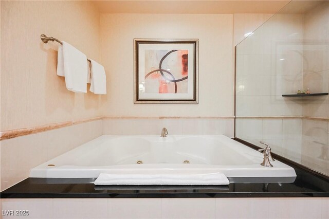 bathroom featuring a tub with jets