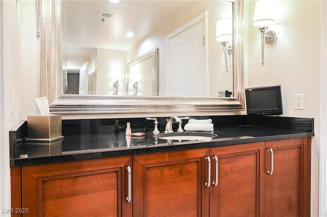 bathroom with vanity and visible vents