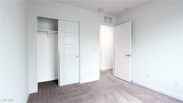 unfurnished bedroom with baseboards, a closet, visible vents, and carpet