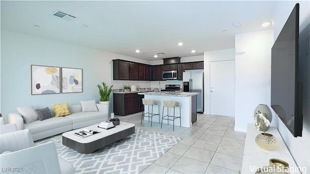 living room with light tile patterned floors, visible vents, and recessed lighting