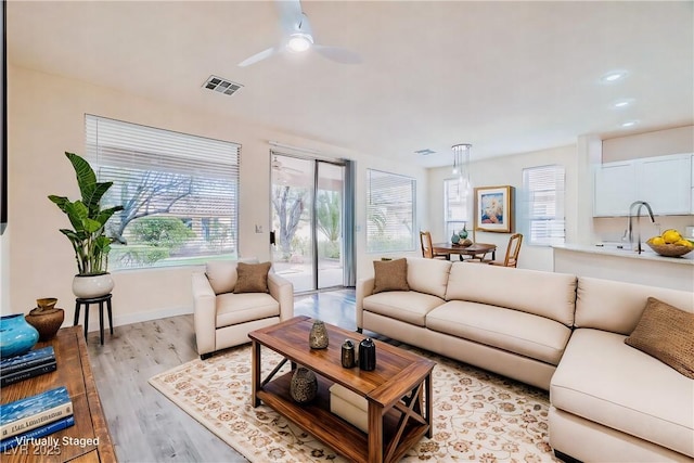 10580 Riva Grande Ct, Las Vegas, NV 89135 - living room featuring healthy amount of natural light, light wood-style floors, a ceiling fan, recessed lighting, and baseboards
