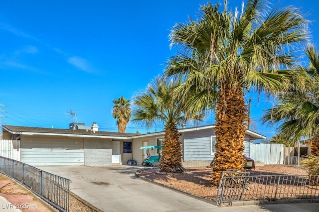 2450 Tournament St, Las Vegas, NV 89142 - view of front of property with brick siding, concrete driveway, and fence