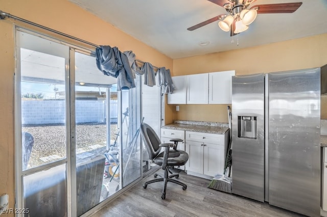 2450 Tournament St, Las Vegas, NV 89142 - kitchen with white cabinetry, stainless steel fridge with ice dispenser, light wood-style floors, and a ceiling fan